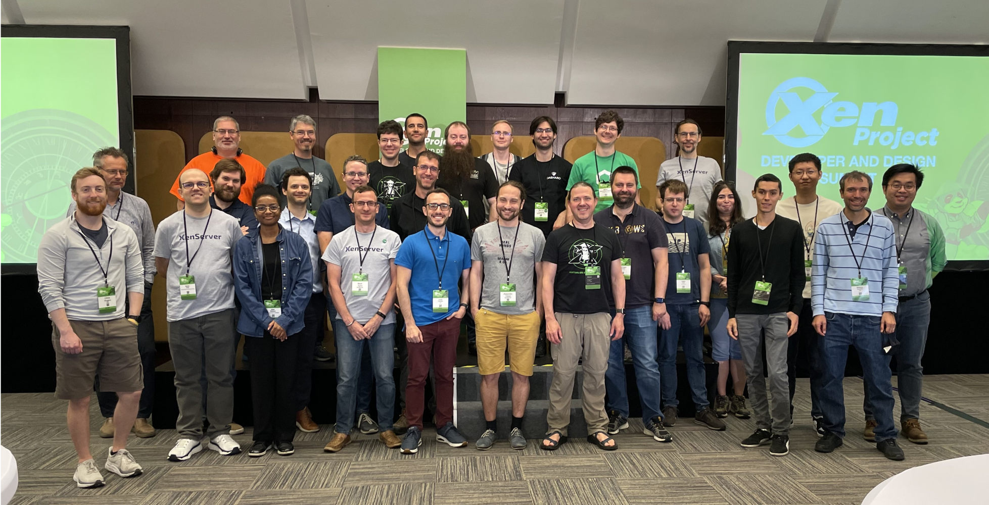 Group photo of attendees at the Xen Project Developer and Design Summit, standing in front of a presentation screen with the Xen Project logo.